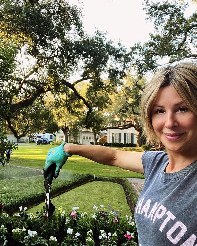Dominique Sachse trimming plants in her garden.